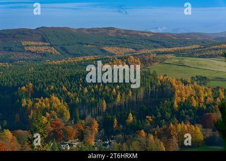 Balmoral Estates Crathie Scozia guardando giù per la valle verso case di proprietà dai colori autunnali tra alberi e foglie Foto Stock