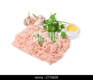 Carne fresca macinata cruda, prezzemolo, uovo e aglio isolati su bianco Foto Stock