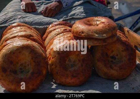 Pane nazionale uzbeko venduto sul mercato - Samarcanda, Uzbekistan. Messa a fuoco selettiva Foto Stock