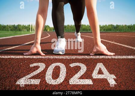 buon anno 2024. concetto di avviare un'attività o una carriera nel nuovo anno. donna che si prepara a correre. inizio dell'anno 2024. transizione a. Foto Stock