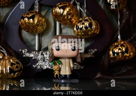 Funko Pop action figure di Hermione Granger con mandrake del film Harry Potter. Luci di zucca di Halloween, palazzo buio, magia, stagione spettrale. Foto Stock