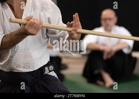 Persona in hakama nero con spada in legno Bokken Foto Stock