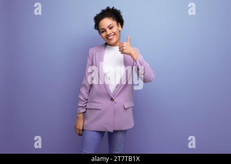 una giovane donna d'affari latina di successo con i capelli in slitta vestita con una giacca punta il dito a farsi un'idea Foto Stock