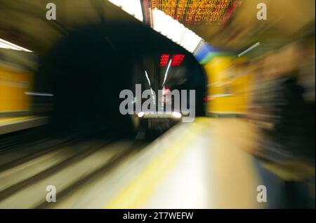 Immagine dinamica di un treno sotterraneo che esce da un tunnel con un accattivante effetto di sfocatura Foto Stock