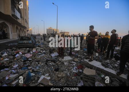 Khan Yunis, territori palestinesi. 18 novembre 2023. I palestinesi ispezionano un edificio distrutto a seguito di un attacco aereo israeliano sulla zona residenziale di Hamad. Credito: Mohammed Talatene/dpa/Alamy Live News Foto Stock