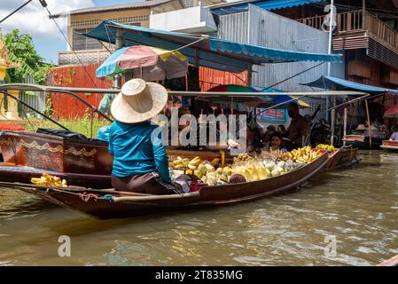 Vari beni, come cibo o bevande tailandesi, sono offerti in vendita su un mercato galleggiante originale Samut Sakhon Thailandia Asia Foto Stock