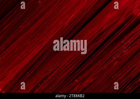 Trefoli in fibra ottica che trasmettono luce rossa, vista macro Foto Stock