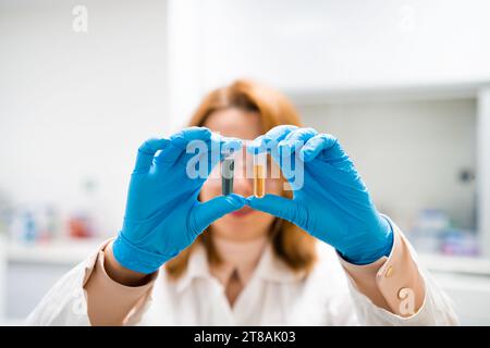 Chiudere due provette nelle mani del ricercatore Foto Stock