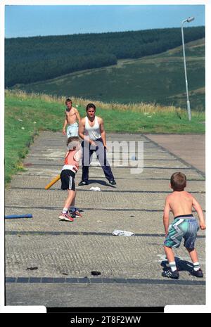 Le famiglie giocano a baseball nella Penrhys Estate su una collina che si affaccia sulla Rhondda Valley nel Galles del Sud, maggio 1997. Foto: ROB WATKINS Foto Stock