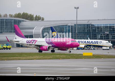 Wizzair Airbus A320 rullaggio per il decollo con Ryanair Boeing 737-800 sullo sfondo Foto Stock