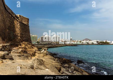 Una vista sull'isola degli inglesi lungo la strada rialzata verso la costa di Arrecife, Lanzarote, in un pomeriggio di sole Foto Stock