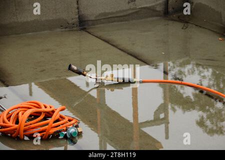 Il tubo flessibile e il bruciatore di una bombola di gas sono nell'acqua Foto Stock