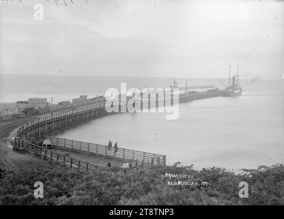 Breakwater, New Plymouth, Fotografia scattata nel 1910 da William Price. Vista generale del frangiflutti di New Plymouth dal lungomare che guarda verso il mare e verso una nave ormeggiata al molo a media distanza Foto Stock