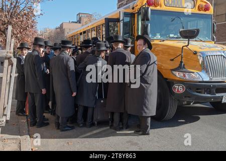Un grande gruppo di ebrei satmar ultra ortodossi di Williamsburg sale a bordo di un autobus per andare a un seminario sul Talmud in un altro quartiere. 19 novembre 2023. Foto Stock