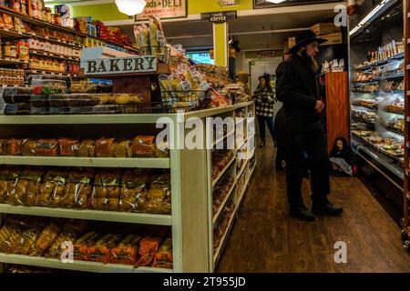 Gli Amish fanno shopping al Doud's Market, il più antico negozio di alimentari d'America. Il negozio ha aperto a Mackinac Island nel 1884. Gli Amish si sentono come a casa sull'isola senza auto, che sembra essere caduta fuori dal tempo, proprio come lo stile di vita Amish. Gli Amish tradizionali e originali sono popolari sull'isola di Mackinac a causa della loro abilità artigianale, ad esempio nella costruzione e riparazione di carrozze. Con i loro abiti, si distinguono difficilmente nel Doud's Market, il più antico negozio di alimentari d'America. Mackinac Island, Michigan, Stati Uniti Foto Stock