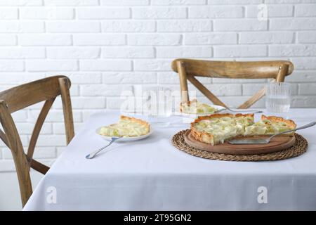 Gustosa torta di porri e bevanda servita al tavolo Foto Stock