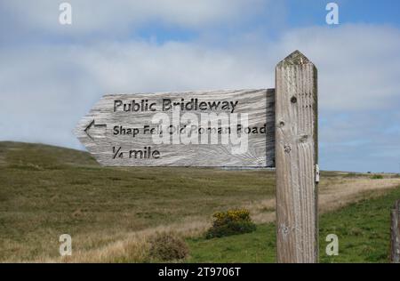Cartello di legno per Bridleway to Shap Fell 'Old Roman Road' dalla cima della A9 Road nel Lake District National Park, Cumbria, Inghilterra, Regno Unito. Foto Stock