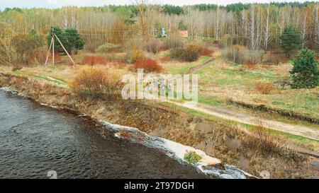 Uomini vestiti da soldati americani americani della fanteria statunitense della seconda guerra mondiale che marciano vicino alla costa del fiume in primavera, il giorno dell'autunno. Gruppo di soldati in marcia Foto Stock