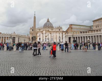 St Piazza Pietro con obelisco egiziano nella città del Vaticano. Molte persone stanno aspettando in fila all'ingresso della famosa St. La Basilica di Pietro. Foto Stock