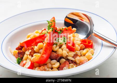 miscela di piselli gialli e pancetta servita con pepe rosso e peperoncino Foto Stock