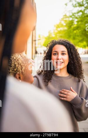 Una giovane donna che parla con amiche mentre passa il fine settimana insieme Foto Stock