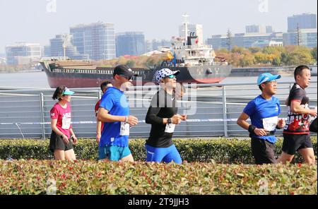 SHANGHAI, CINA - 26 NOVEMBRE 2023 - i corridori gareggiano nella Shanghai International Marathon a Shanghai, Cina, 26 novembre 2023. Foto Stock