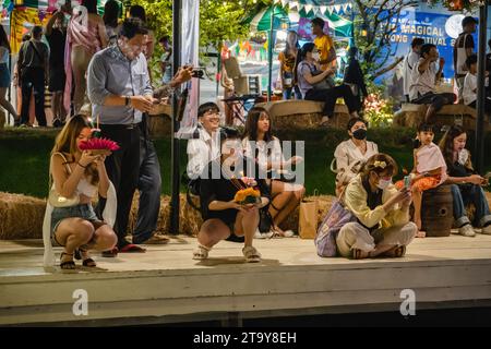 Tailandesi e stranieri sono visti con il loro krathong, sulla riva del lago, durante il magico Loy Krathong Festival, al Jodd Fairs Dan Neramit, a Bangkok. Loy Krathong 'per galleggiare rituale vaso o lampada' è un festival thailandese celebrato ogni anno in tutta la Thailandia†e nei paesi vicini, dove la notte della luna piena, i Krathong, decorati con foglie di banana riccamente piegate, tre bastoncini di incenso, e una candela, vengono lanciate dai thailandesi, su un fiume, un canale o uno stagno, facendo un desiderio come fanno. (Foto di Nathalie Jamois/SOPA Images/Sipa USA) Foto Stock