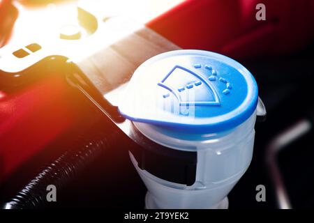 Chiudere il tappo blu del serbatoio del liquido lavavetro nel vano motore. Foto Stock