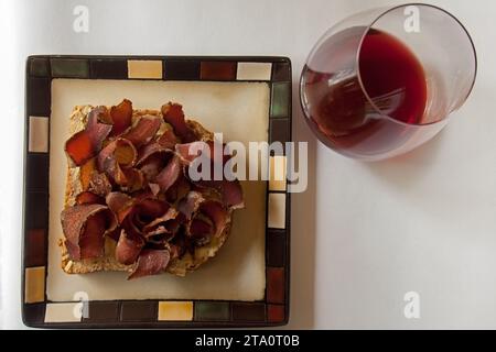 Biltong affettato su pane e vino rosso 14409. Foto Stock