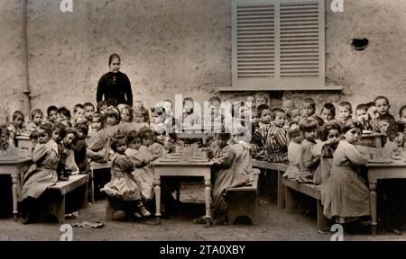 1900 bambine e ragazzi dell'asilo pompeiano pranzano nei locali della scuola. Old Picture from the Orphanage for Children è stato fatto un lavoro di beneficenza per gli orfani o è stato fornito sostegno agli orfani in qualche modo. Cattedrale di Pompei - Santuario della Madonna del Rosario di Pompei, fondato nel 1876 - 1891, Italia, Italia, Foto Stock