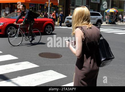 New York, USA - 30 maggio 2018: Donna usa il suo smartphone per strada a New York. Foto Stock