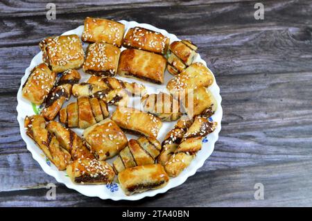 Pasta farcita con datteri e condita con semi di sesamo o Ka'ab El Ghazal, datteri egiziani o biscotti ripieni di Agwa Ajwa, famosa fille di datteri mediorientali Foto Stock