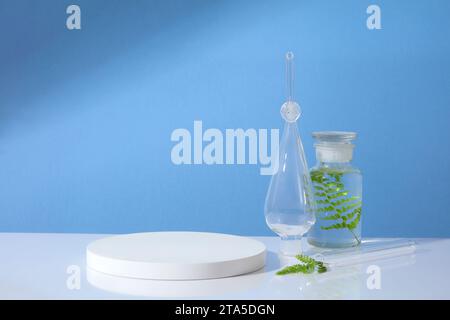 Podio bianco a forma rotonda con spazio vuoto dotato di un vaso in vetro e di una provetta con foglie verdi. Scena minimalista con podio e backgrou astratto Foto Stock