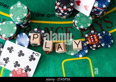 La parola poker su cubetti di legno, poker chips con carte da gioco sul tavolo verde del casinò. gamble Foto Stock