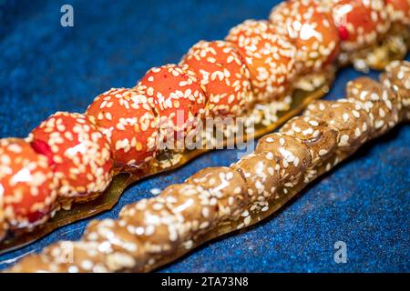 Mucche ricoperte di zucchero su un bastone, cibo tradizionale cinese, cibo di strada Foto Stock