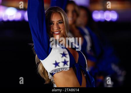 Una cheerleader dei Dallas Cowboys si esibisce durante una gara di stagione regolare contro i Washington Commanders, giovedì 22 novembre 2023, all'AT&T Stadium di Foto Stock