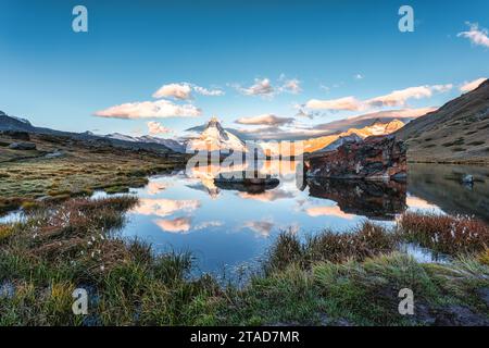 Splendido paesaggio del lago Stellisee con la montagna simbolo del Cervino, le alpi svizzere e la riflessione di pietre al mattino a Zermatt, in Svizzera Foto Stock
