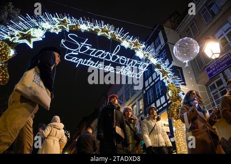 Gli acquirenti riempiono le strade di Strasburgo, in Francia, durante i mercatini di Natale annuali nella città orientale della Francia. I mercati sono uno dei più antichi d'Europa, essendo operativi da oltre 400 anni. Si stima che oltre due milioni di persone visiteranno la città durante la stagione di Yule del 2023. Foto Stock