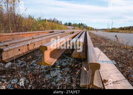 Molti hanno utilizzato rotaie arrugginite di diversa lunghezza conservate su un lato della rotaia per la sostituzione di vecchie rotaie. Foto ravvicinata con vista di basso livello Foto Stock