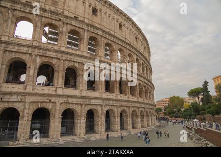 Vista ravvicinata del Colosseo a Roma, Italia, con i turisti che passeggiano. Il Colosseo italiano è un anfiteatro ovale nel centro della città di R. Foto Stock