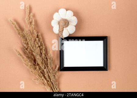 Modello con cornice a foto con zucca decorativa su sfondo beige, Ringraziamento, poster festivo di Halloween. Foto Stock