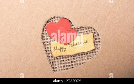 Icona di amore e il giorno di San Valentino testo sulla carta strappata Foto Stock