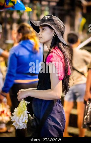 Una giovane ragazza filippina vende ghirlande di fiori alla chiesa di Santo Nino de tondo a Manila, nelle Filippine. Foto Stock