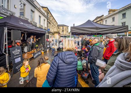 Gruppo rock che suona musica per un grande pubblico sul palco degli autobus al Frome Christmas Sunday Market di Frome, Somerset, Regno Unito, il 3 dicembre 2023 Foto Stock