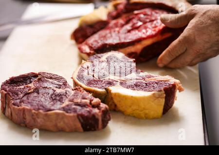 Preparazione di una bistecca di costolette “entrecote Bordelaise” (bistecca alla Bordeaux), Bazas beef. Taglio della carne Foto Stock