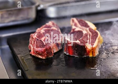 Preparazione di una bistecca di costolette “entrecote Bordelaise” (bistecca alla Bordeaux), Bazas beef. Cucina a base di carne, carne rara Foto Stock