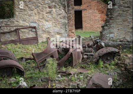 I resti di un'auto di una casa bruciata durante la guerra Foto Stock