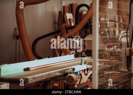 Una macchina CNC all'avanguardia in un moderno impianto di lavorazione del legno mette in mostra la perfetta fusione tra tecnologia di precisione e tradizione Foto Stock