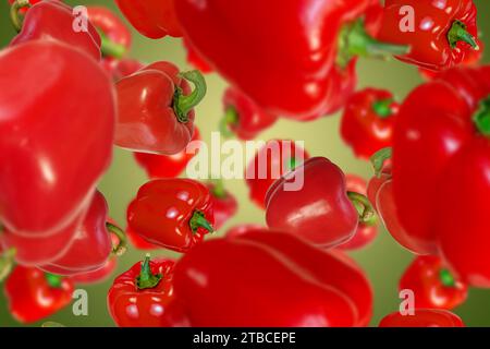 Peperoni rossi che cadono su sfondo giallo. Foto Stock