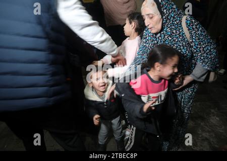 Rafah, Gaza. 6 dicembre 2023. Una donna con bambini viene aiutata da un uomo a seguito di uno sciopero israeliano a Rafah nella Striscia di Gaza meridionale, il 6 dicembre 2023. Israele ha ampliato la sua offensiva contro Hamas nella Striscia di Gaza meridionale assediata, intrappolando civili secondo le Nazioni Unite. Foto di Ismael Mohamad/UPI. Crediti: UPI/Alamy Live News Foto Stock